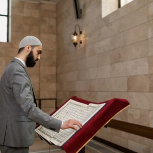 A Bearded Man in Gray Suit Reading a Koran