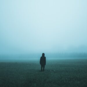 person standing on misty ground