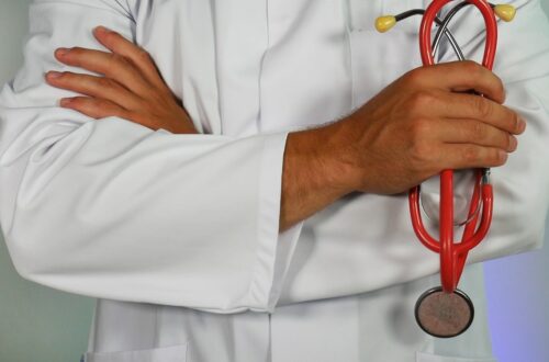 doctor holding red stethoscope