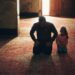 boy in black long sleeve shirt sitting beside girl in gray sweater