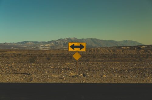 yellow arrow road sign