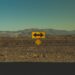 yellow arrow road sign