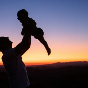 silhouette of man and woman kissing during sunset