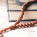 brown beaded necklace on brown wooden table