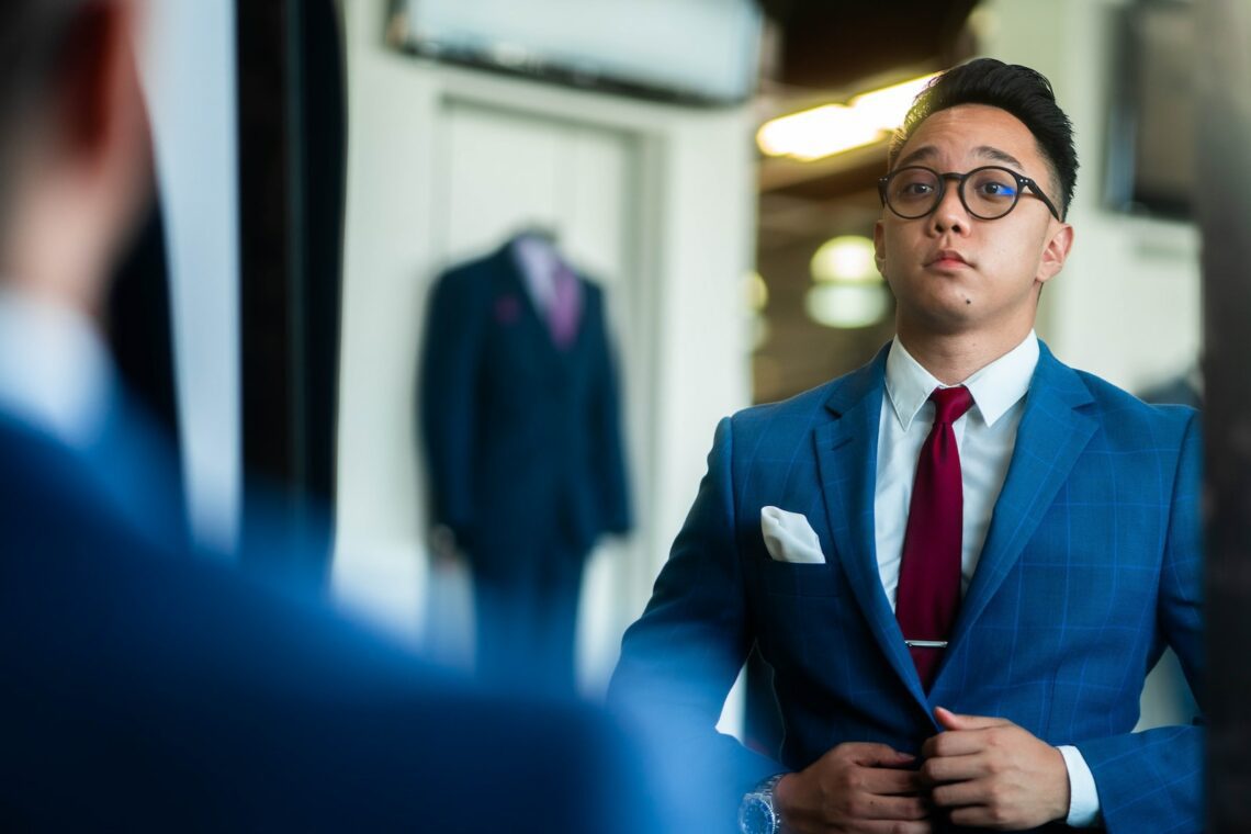 man in black suit wearing eyeglasses