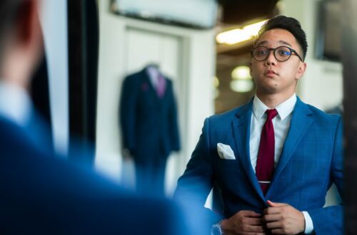 man in black suit wearing eyeglasses